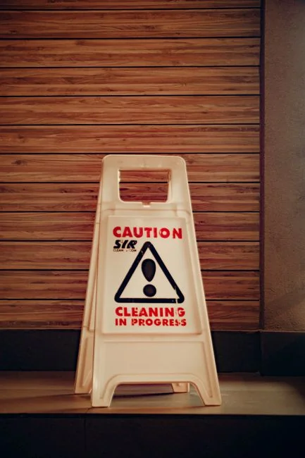 Cleaner using a vacuum in a stylish indoor setting, showcasing cleaning equipment and techniques.